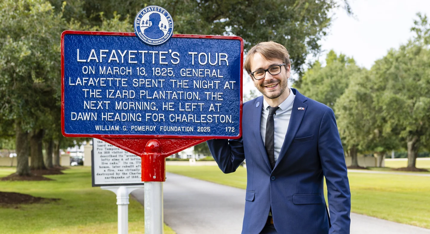 Julien P. Icher beside a Lafayette’s Tour historical marker